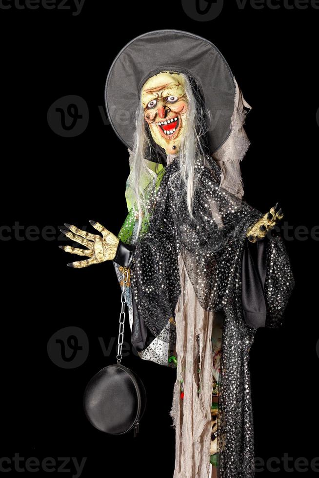 Halloween holiday, Death doll with a black hat and dirty rags. photo