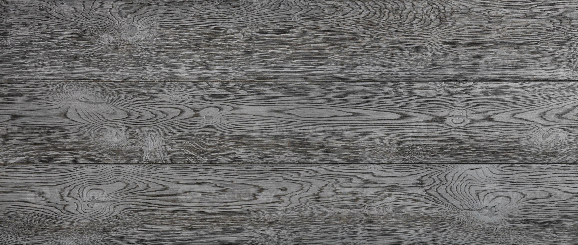 Expressive texture of black wood planks with longitudinal grains and knots. photo