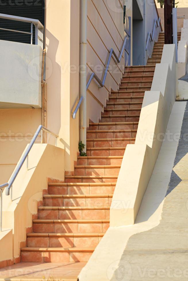 The steps of the stone stairs, paved with paving tiles, rise up. photo