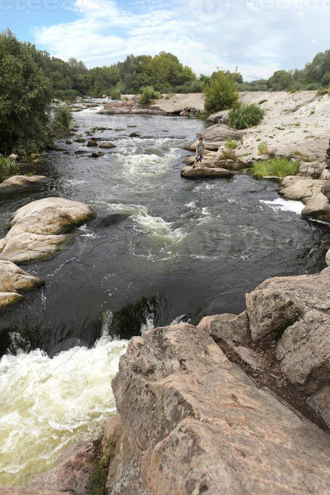 A view of the river rapids and the rapid water flow of the Yuzhny Bug River in the summer photo