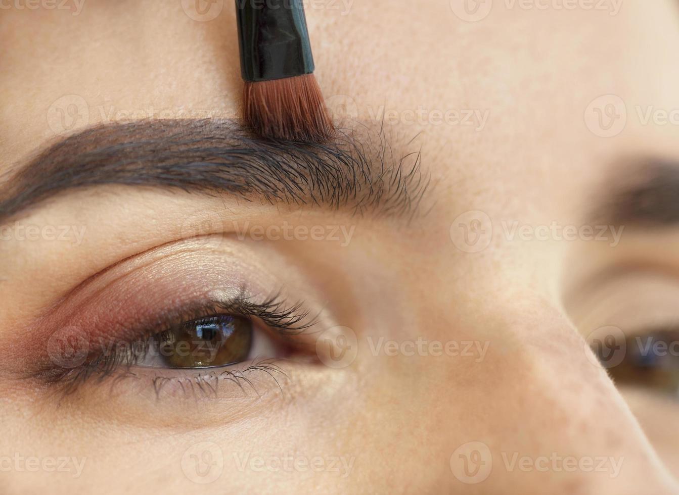 Makeup close-up. Eyebrow makeup, soft brush. photo