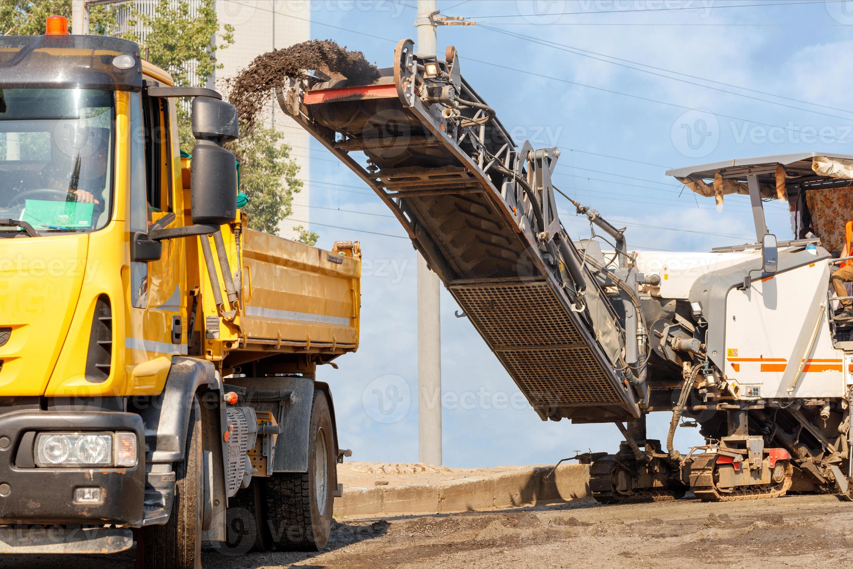 The road milling machine removes the top layer of asphalt from the road