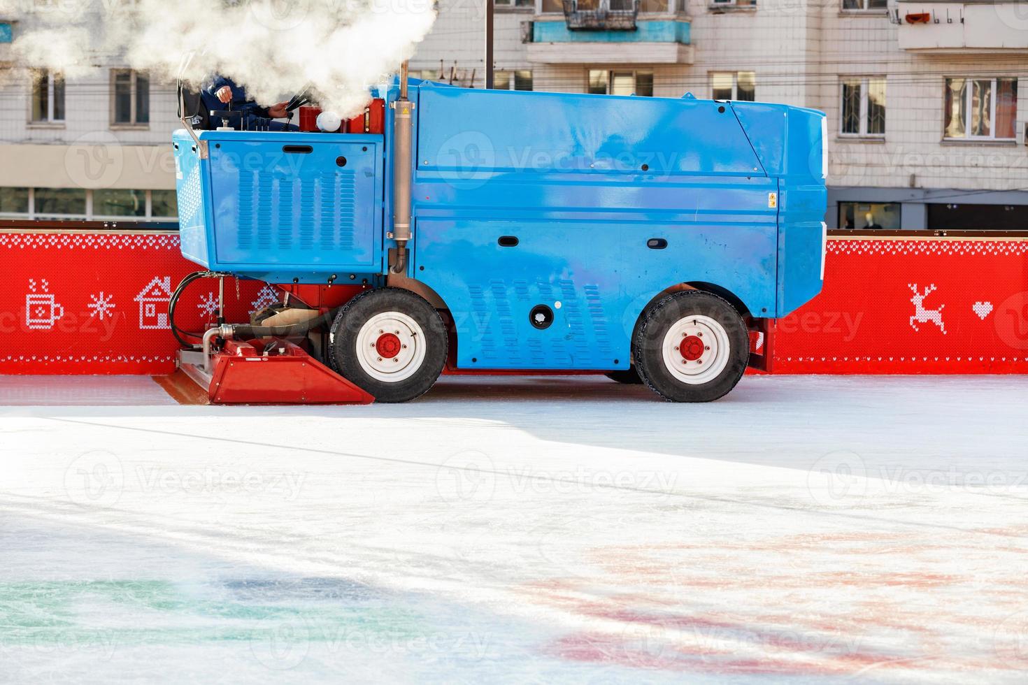 An industrial machine cleans and polishes an ice rink in a stadium on a