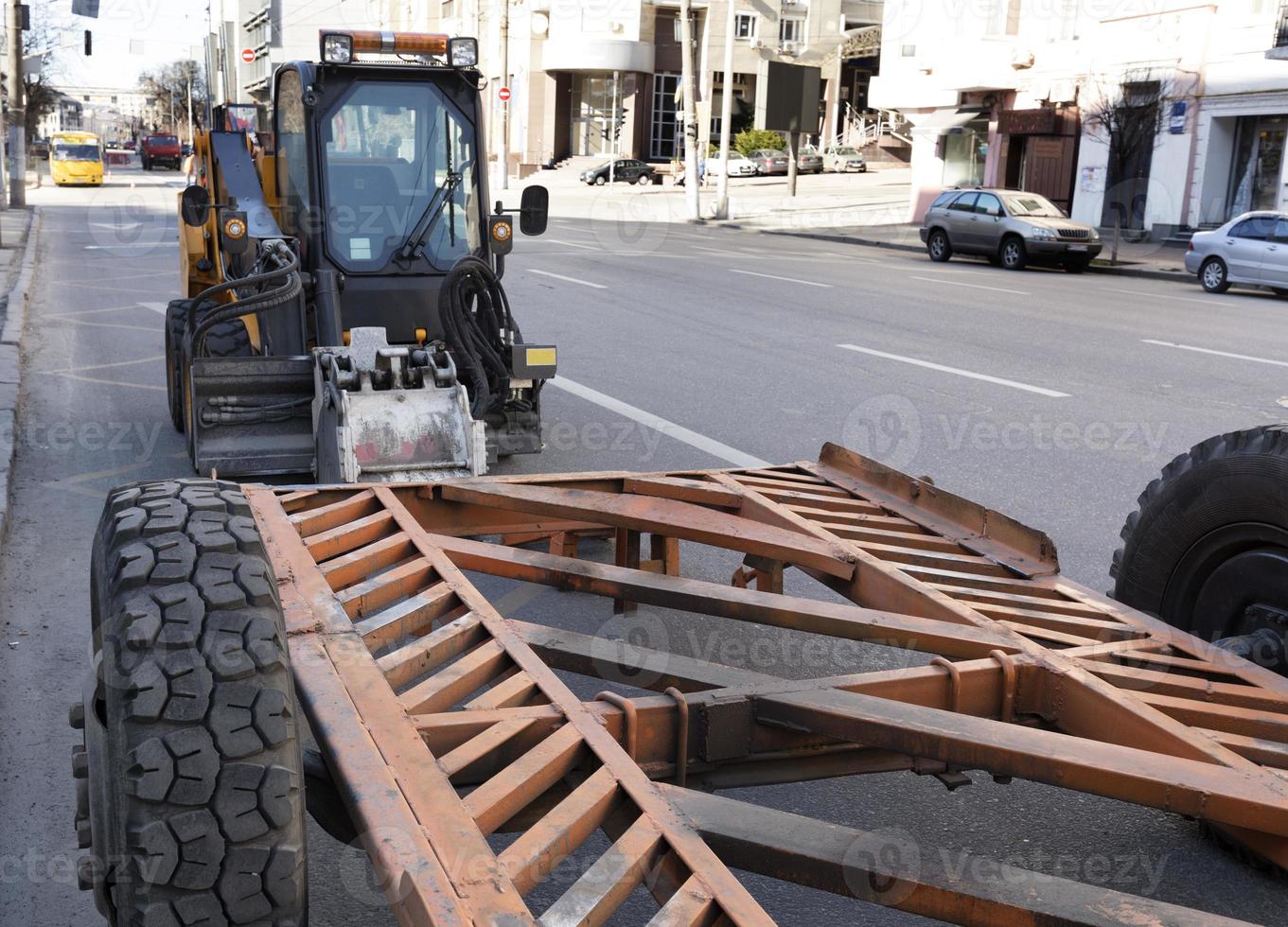 Tractor with a nozzle for repair of damages on asphalt. photo