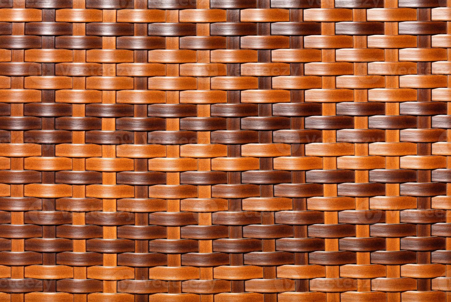 Beautiful brown pattern of artificial rattan with top and side lighting, close-up. photo
