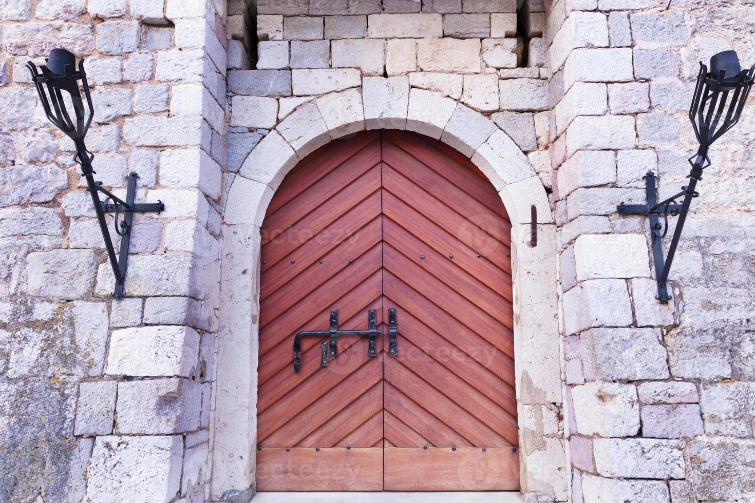 la entrada principal con portones de madera de la antigua fortaleza de piedra. foto