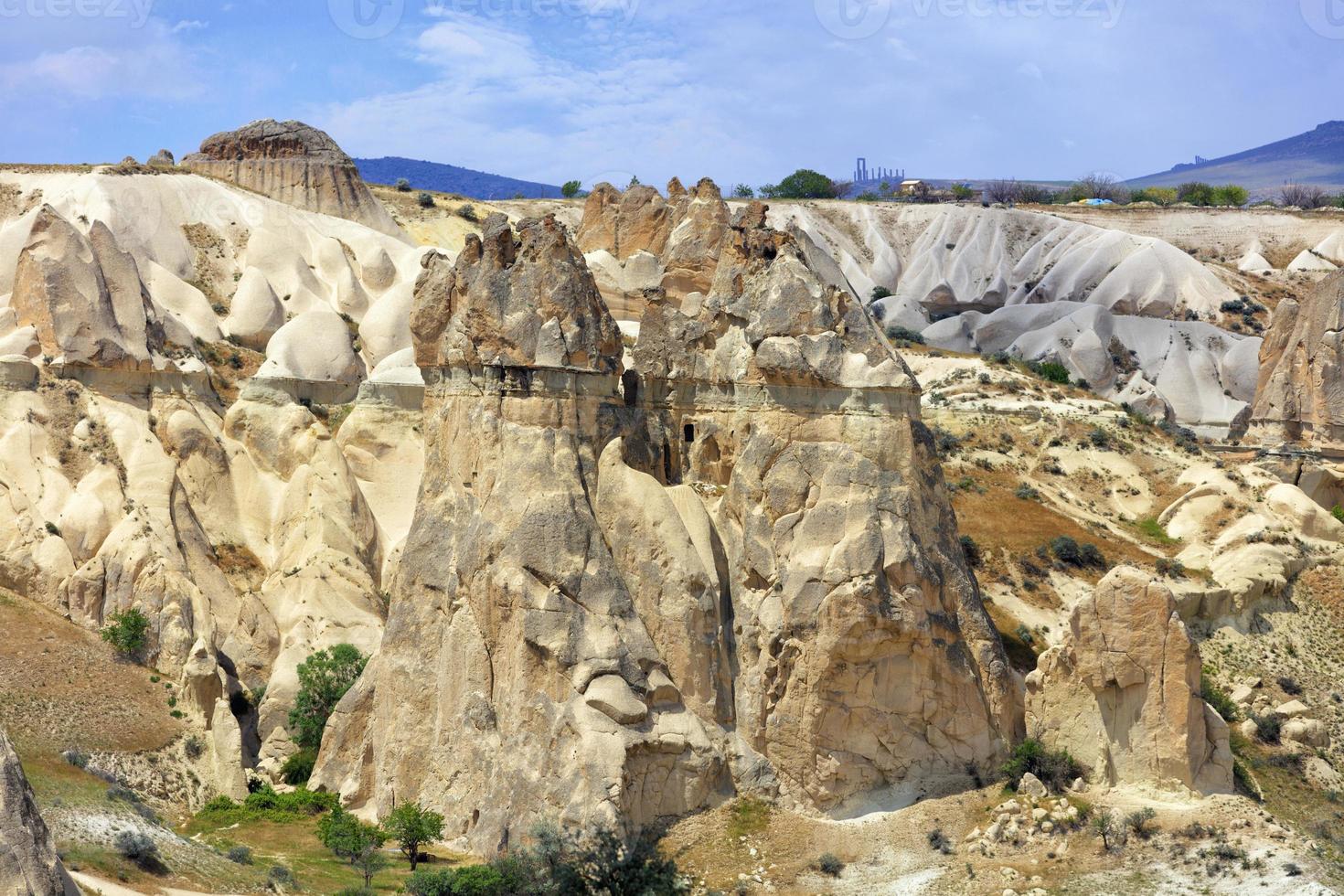 Huge old and weathered rocks in the honey valley of Cappadocia photo