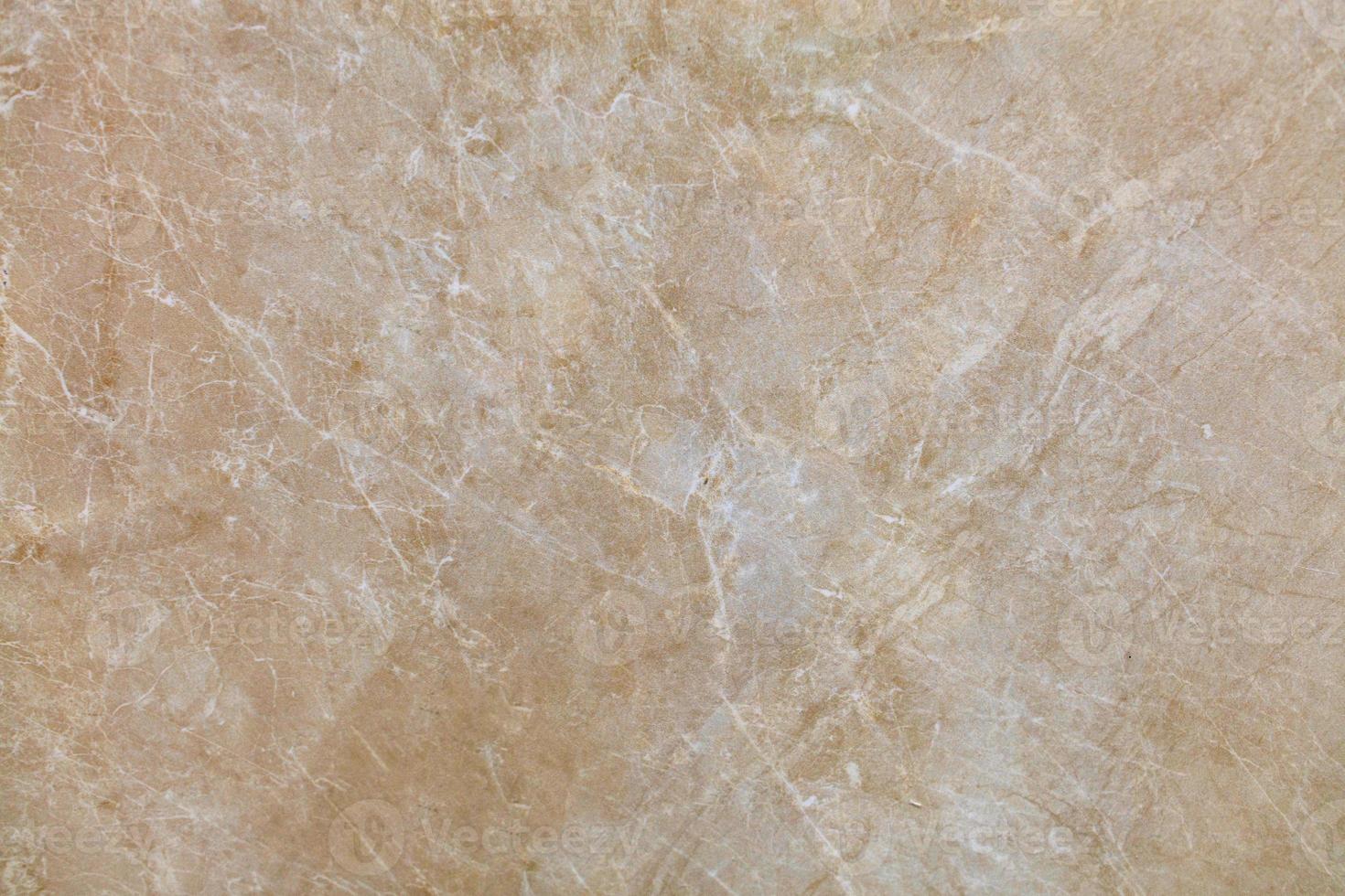 The surface, texture and background of beige marble with small whitish cracks. photo