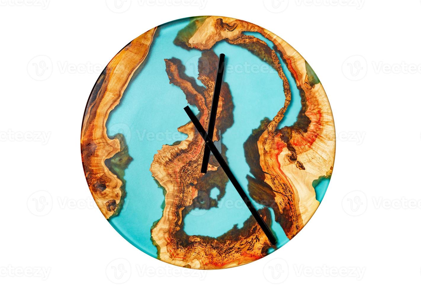 Beautiful wooden wall clock made of tree root and epoxy isolated on a white background. photo