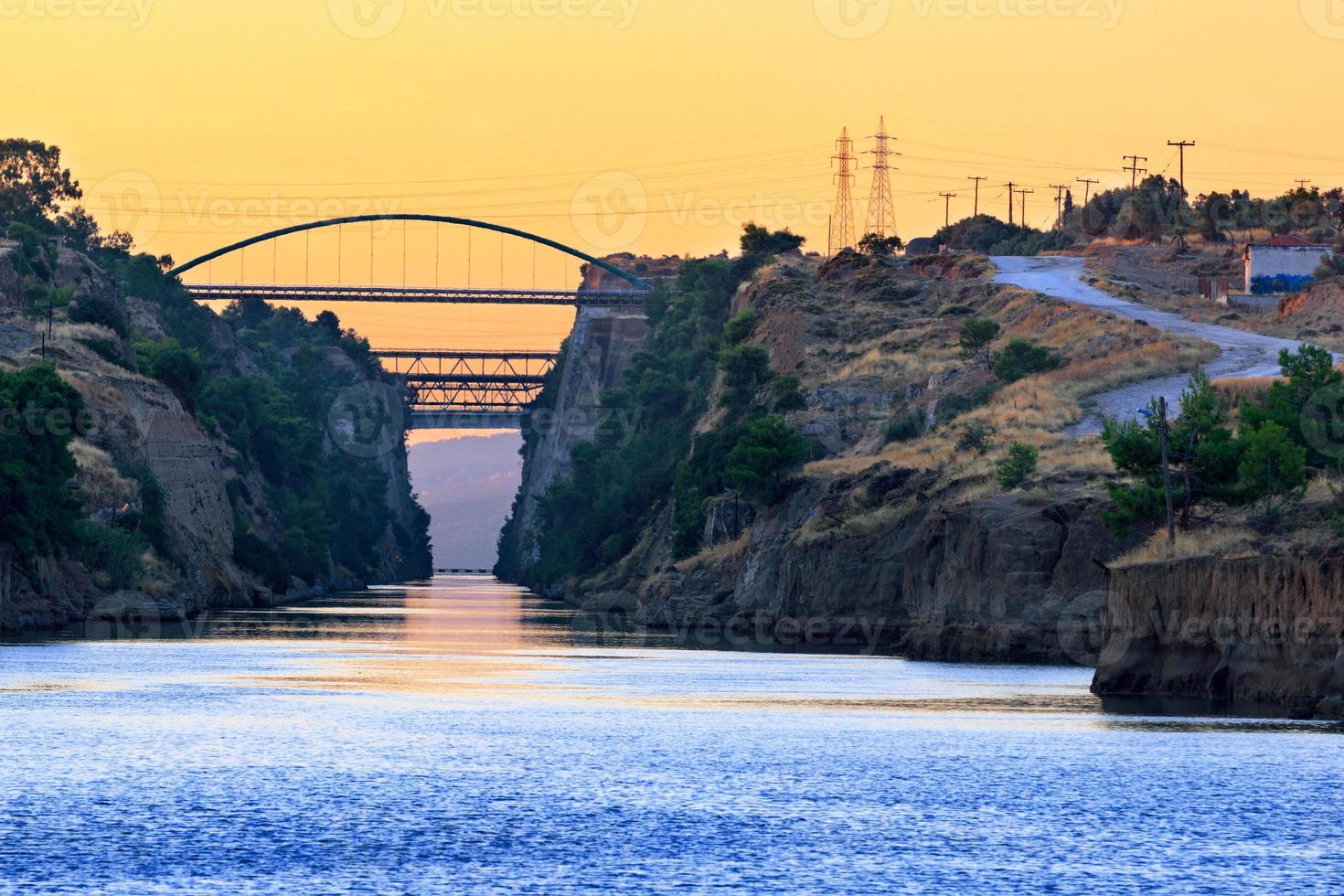 The Corinth Canal transport corridor between two seas in Greece in the early morning haze. photo