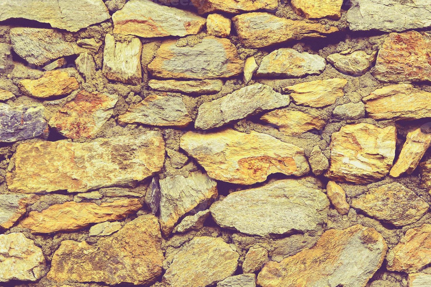 Muro de piedra perfectamente organizado, textura amarilla y gris de textura de fondo de pared de roca foto