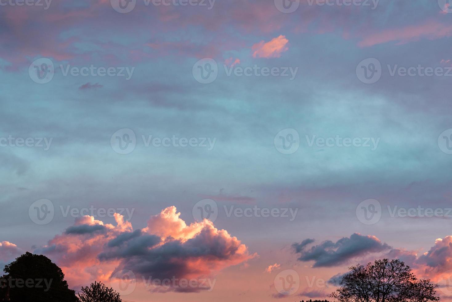 Beautiful summer sunset with orange sky and clouds photo