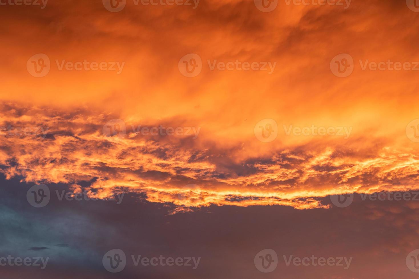 Beautiful summer sunset with orange sky and clouds photo