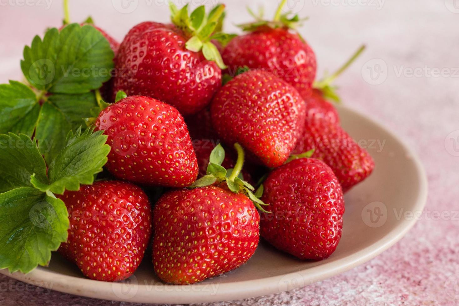 Heap of fresh strawberries in ceramic bowl photo