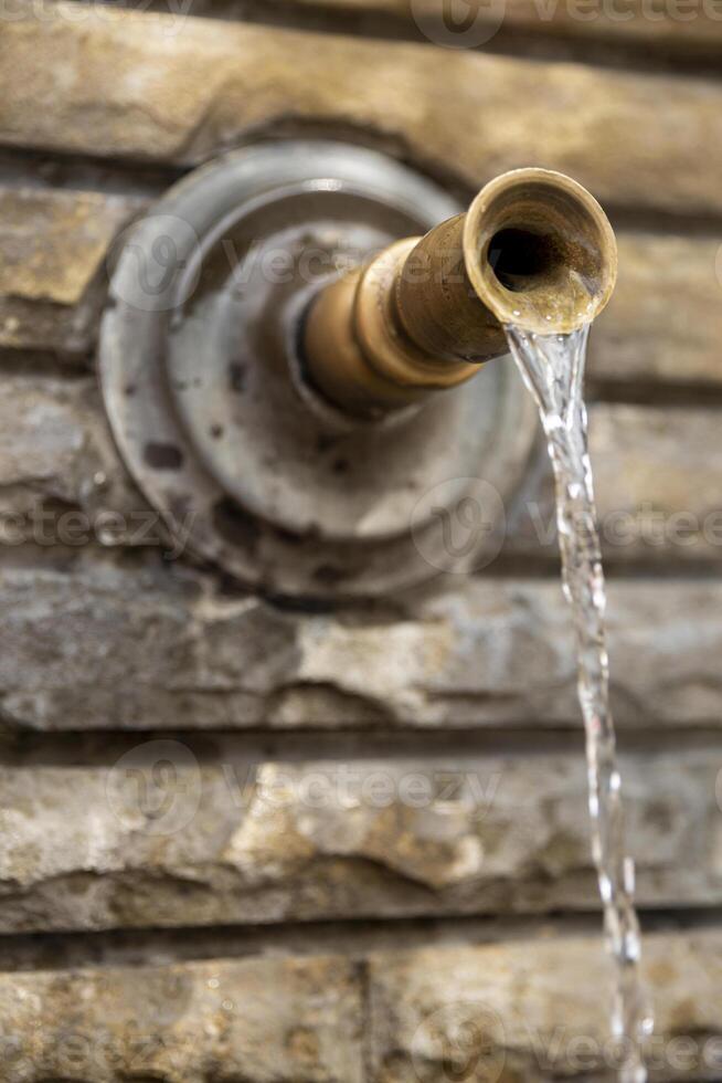 Close-up of the spout of a mountain fountain. photo