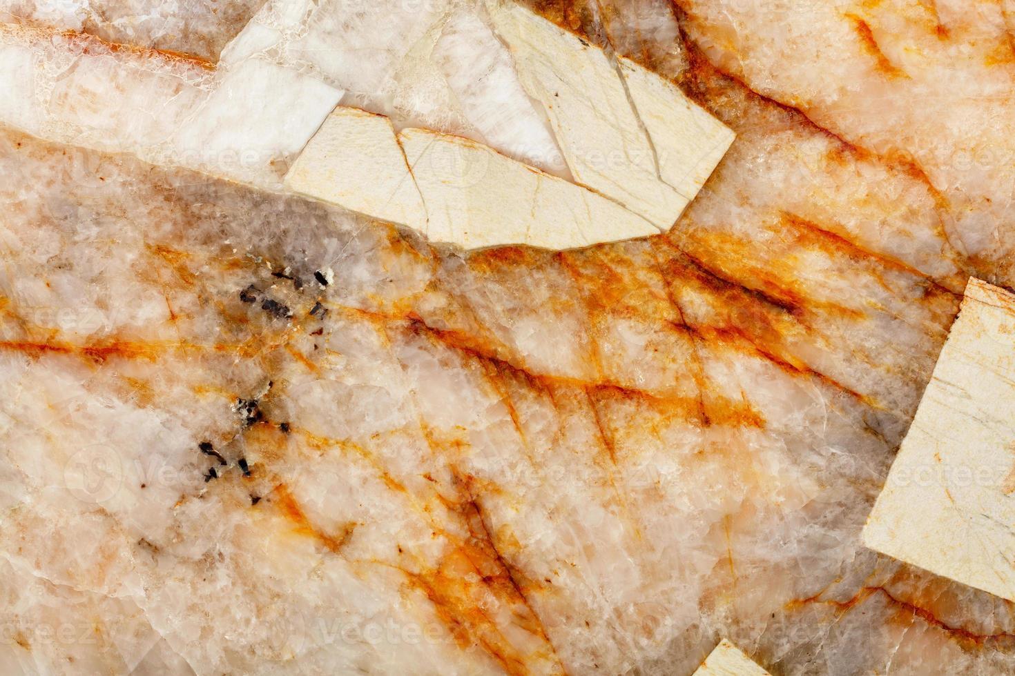 Cracks and blotches on the surface of beige marble close-up. photo