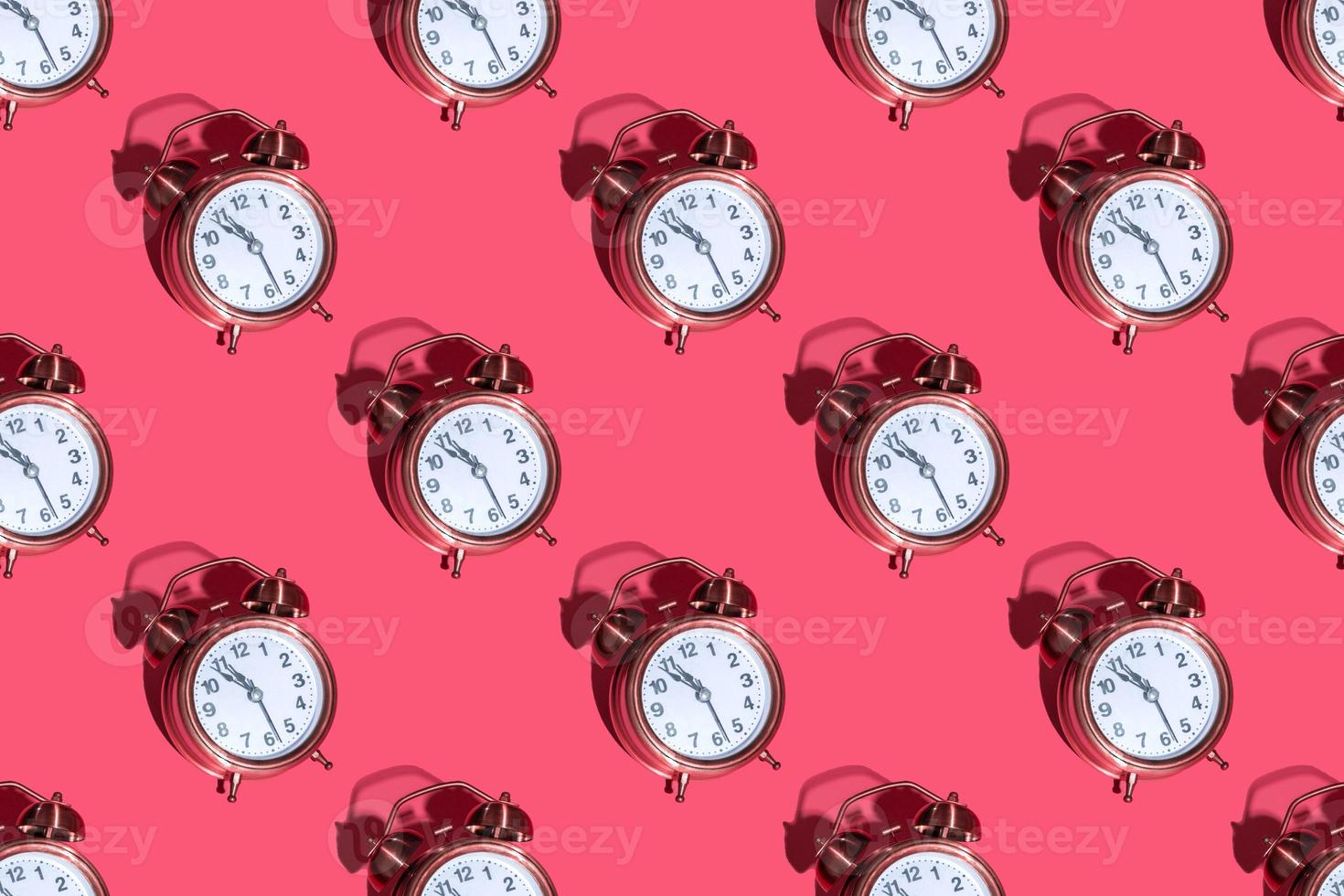 Alarm clock on a colored background hard shadows. Close up. Seamless patterns photo