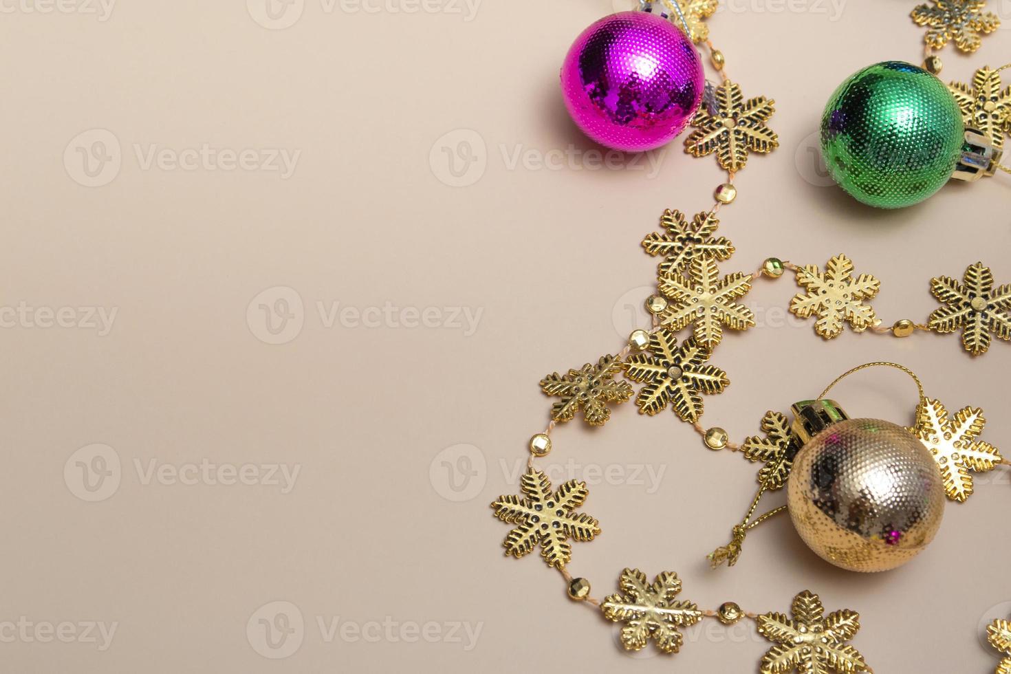 Mock up close-up New Year's top view, spruce multicolored toys with golden snowflakes. Postcard layout. photo