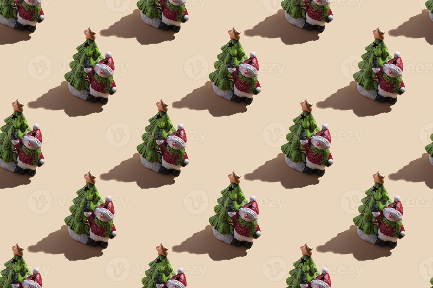 New Year's card close-up a snowman with a Christmas tree on a beige background with a hard shadow. seamless pattern photo