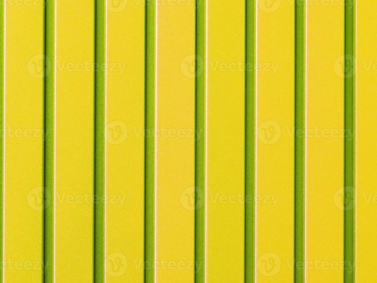 Yellow corrugated steel sheet with vertical rails. photo