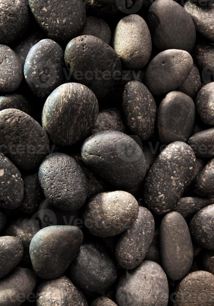 Texture of dried round gray river stone background photo