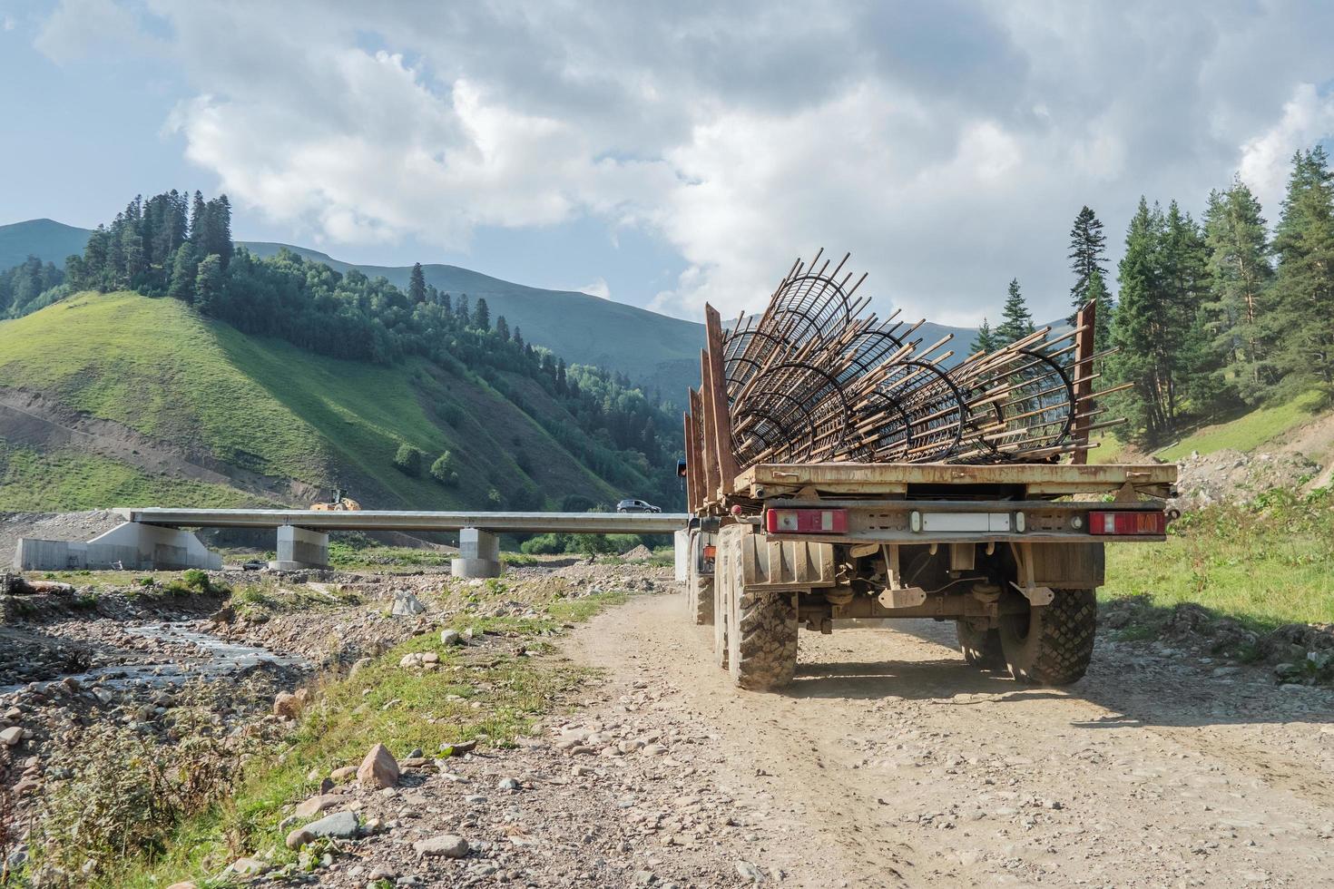 A truck transports a frame made of reinforcement for the construction of the bridge support structures. photo