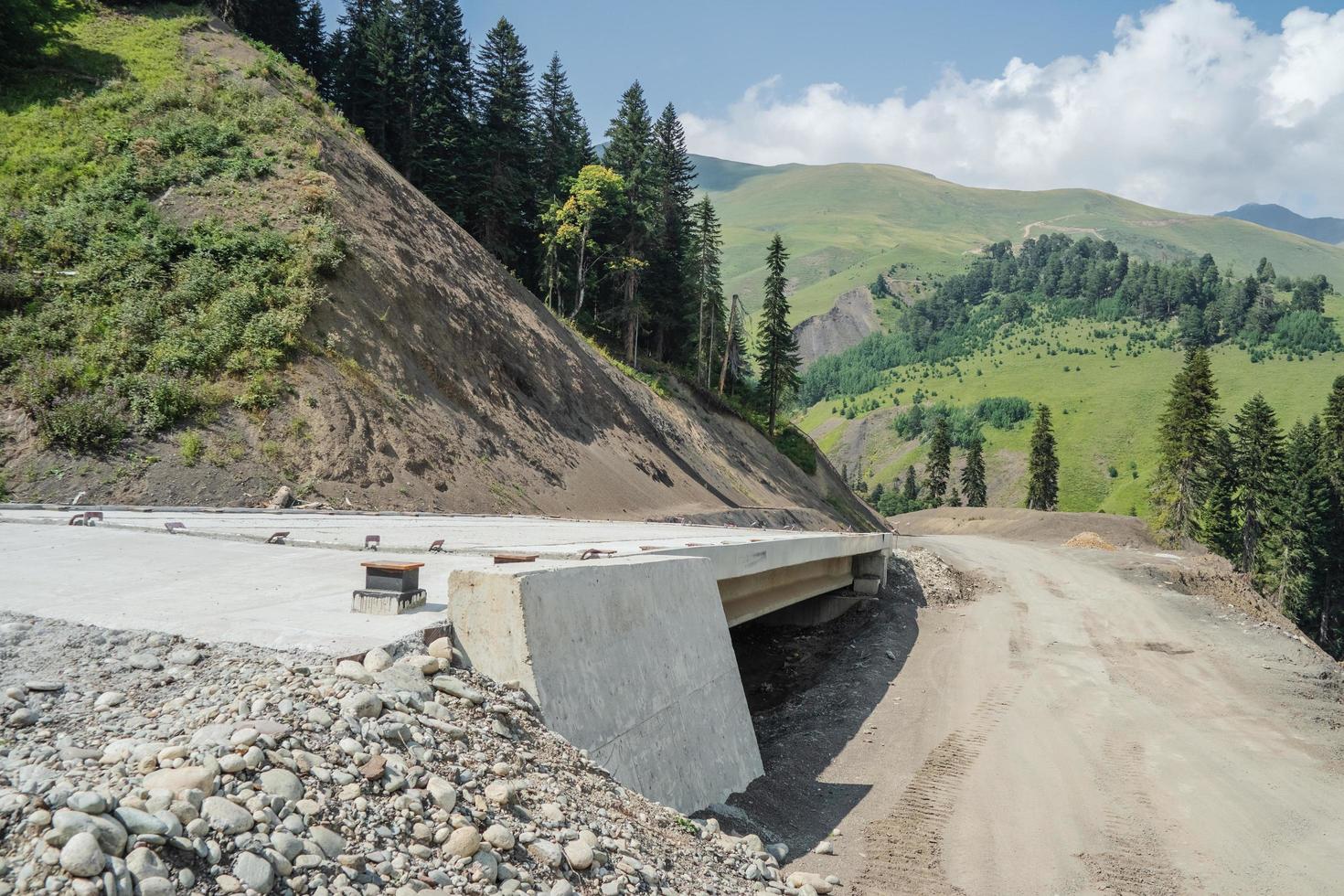 Unfinished bridge in the mountains. Concrete structure on a road in the highlands. photo