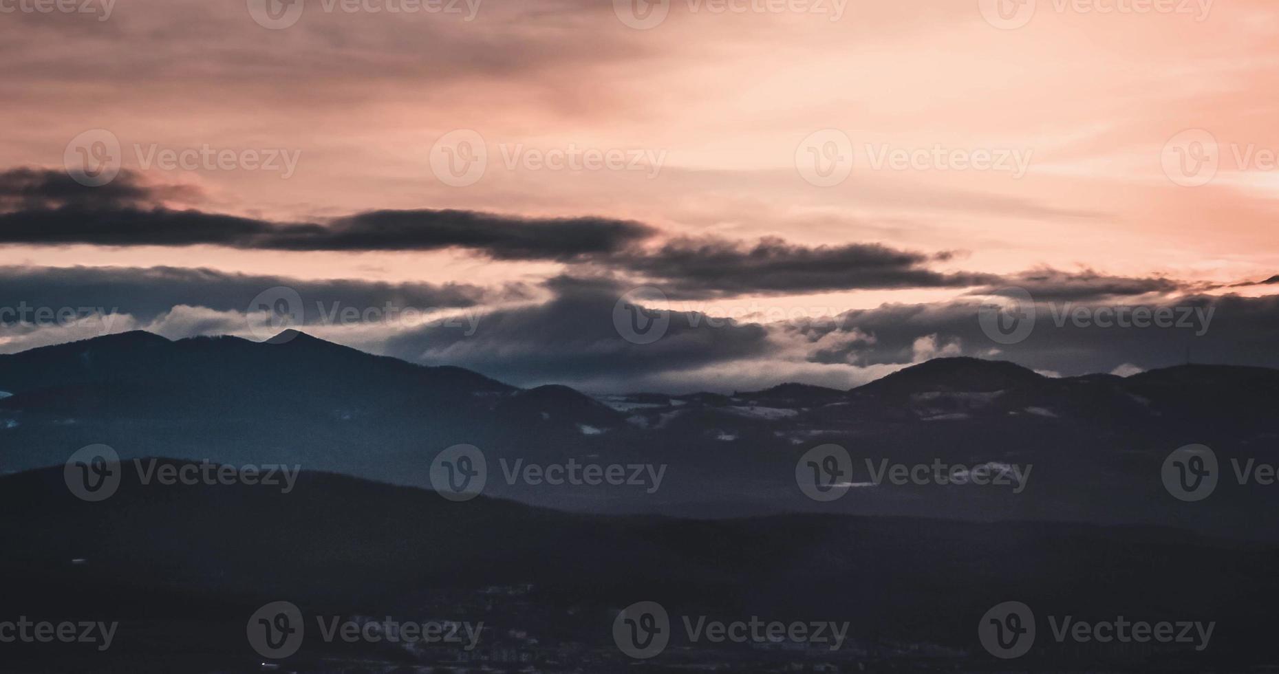 Pink orange cloudy winter sunset timelapse over Cluj photo