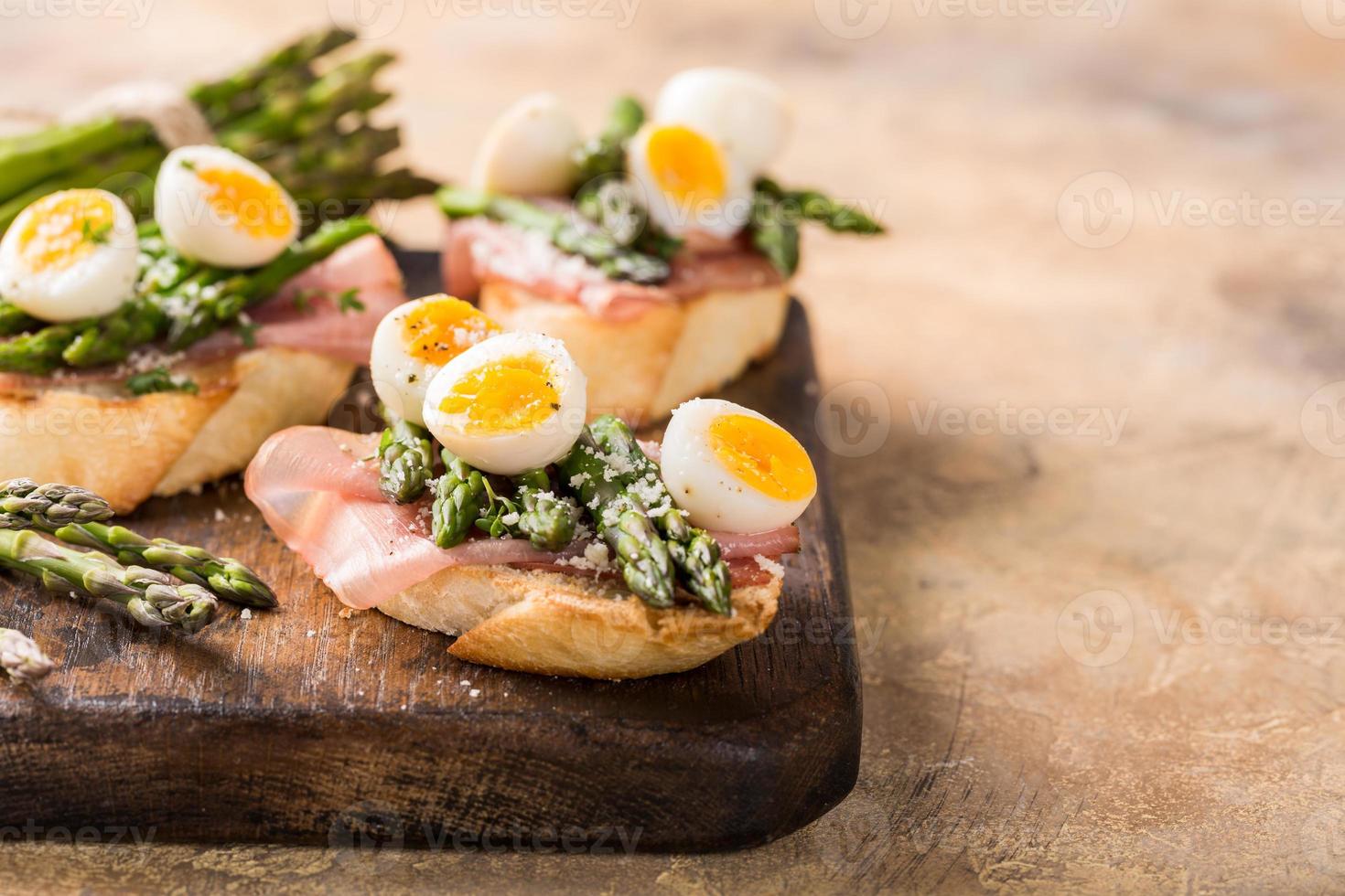 Fresh sendwich with ham, asparagus and quail eggs photo