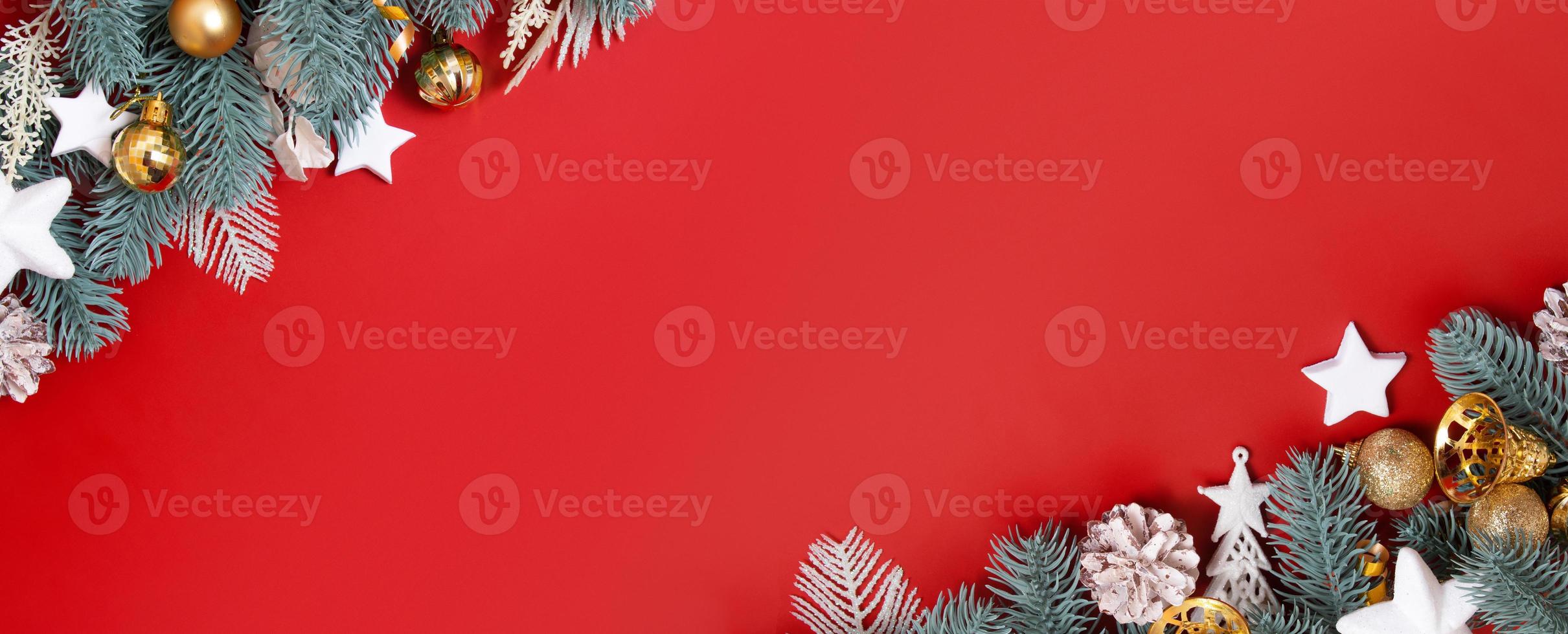 christmas background with golden white decorations on red backdrop with copy space. Flat lay. Banner format photo