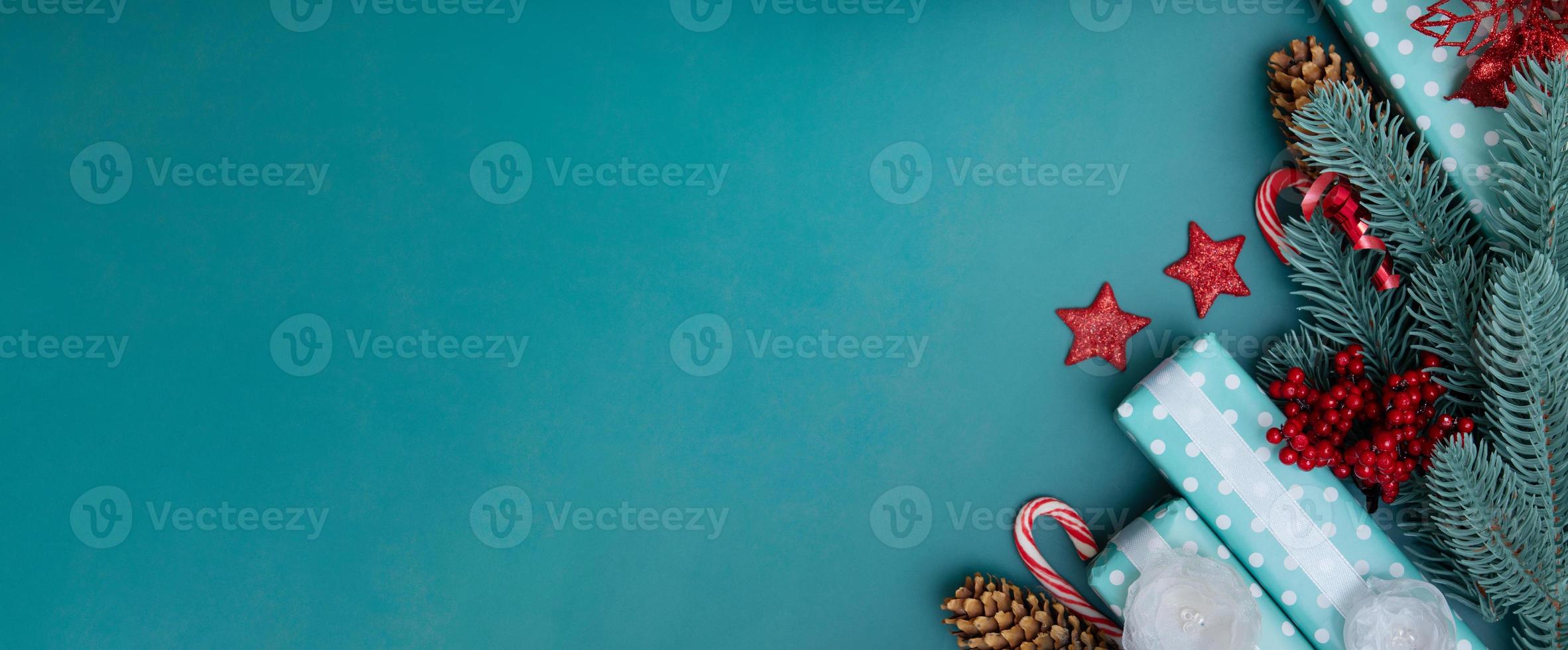 Christmas greeting banner with flat lay winter holidays decorations on turquoise background photo