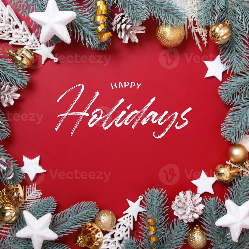 Frame made of Christmas decorations and Happy Holidays text on red background photo