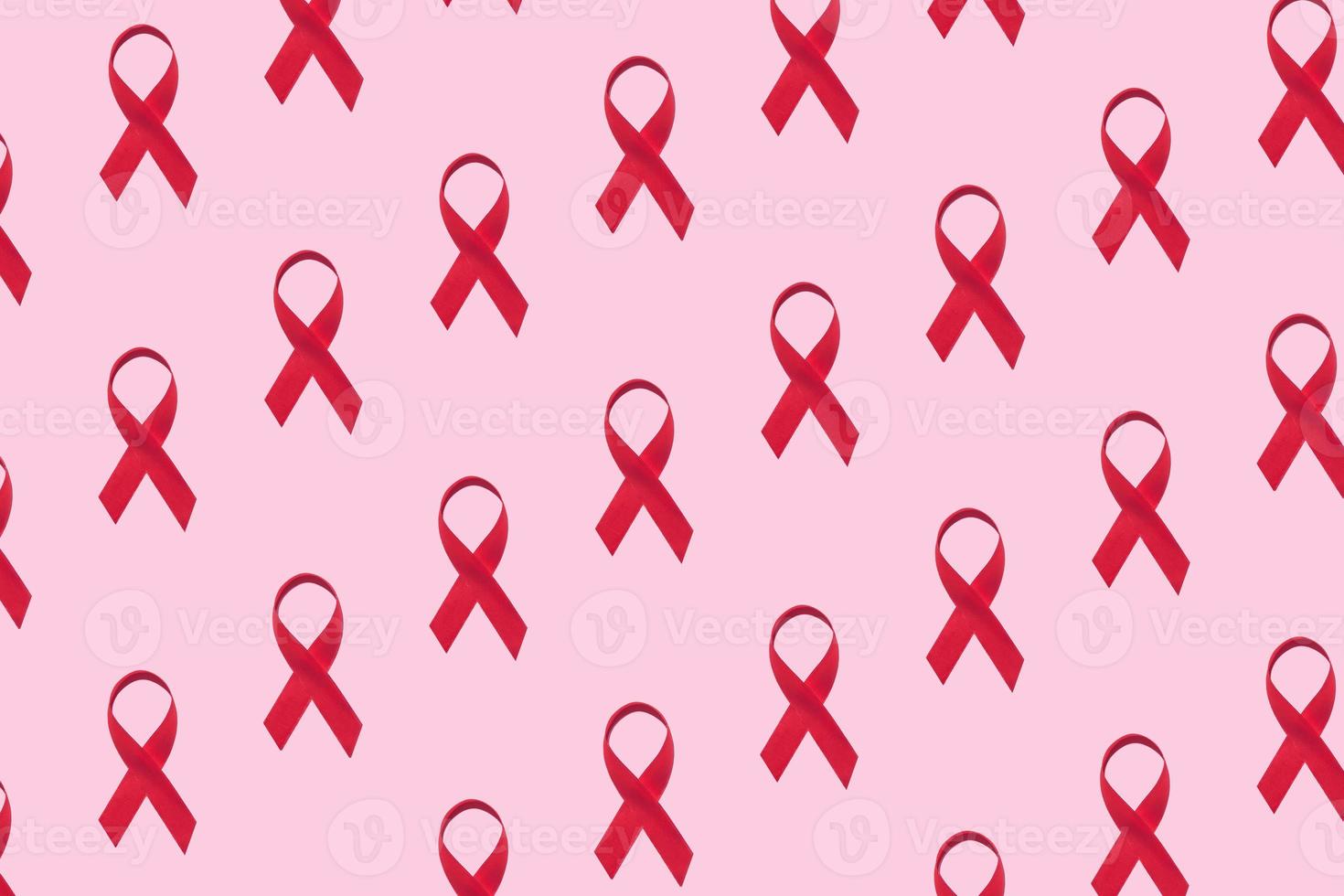 Red ribbons pattern symbol of world aids day on pink background photo