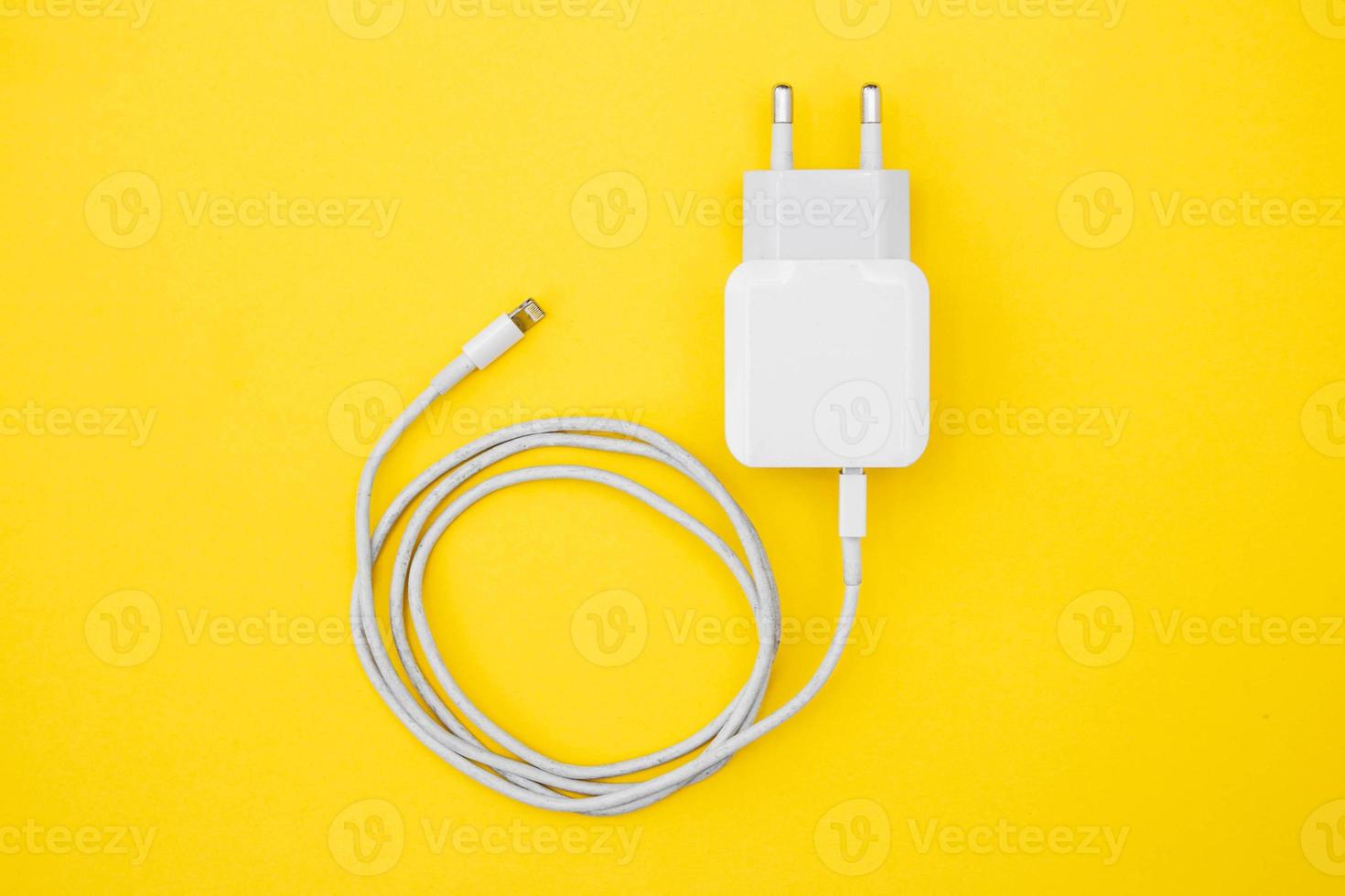 Cargador de móvil y cable usb sobre fondo amarillo foto