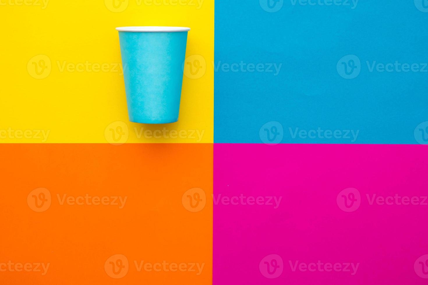 Blue paper disposable cup on beautiful multicolored background photo