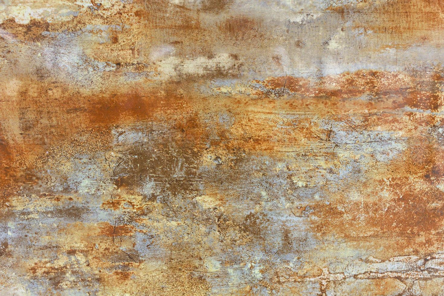 The surface, texture and background of a brown steel sheet of metal with beige rusty spots and patina. photo