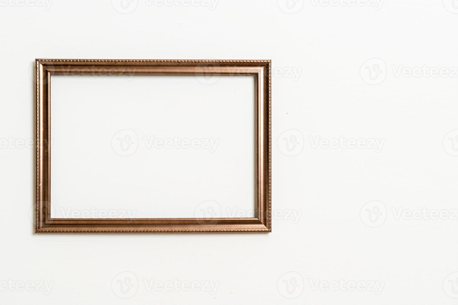 empty picture frame on white wall background photo