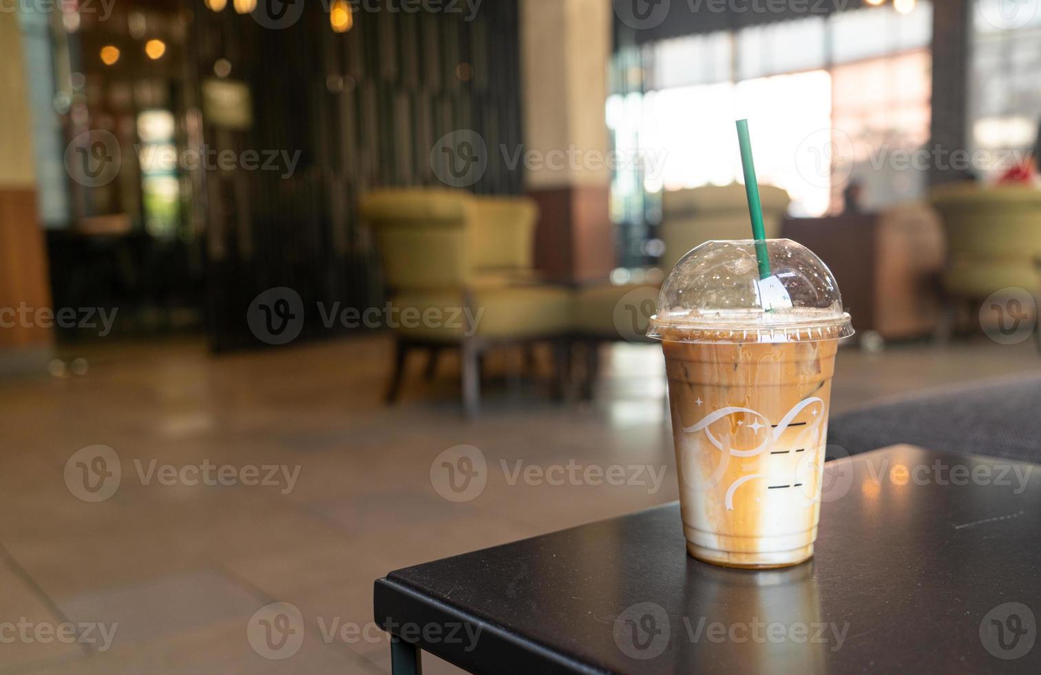 caramel macchiato coffee cup in coffee shop photo