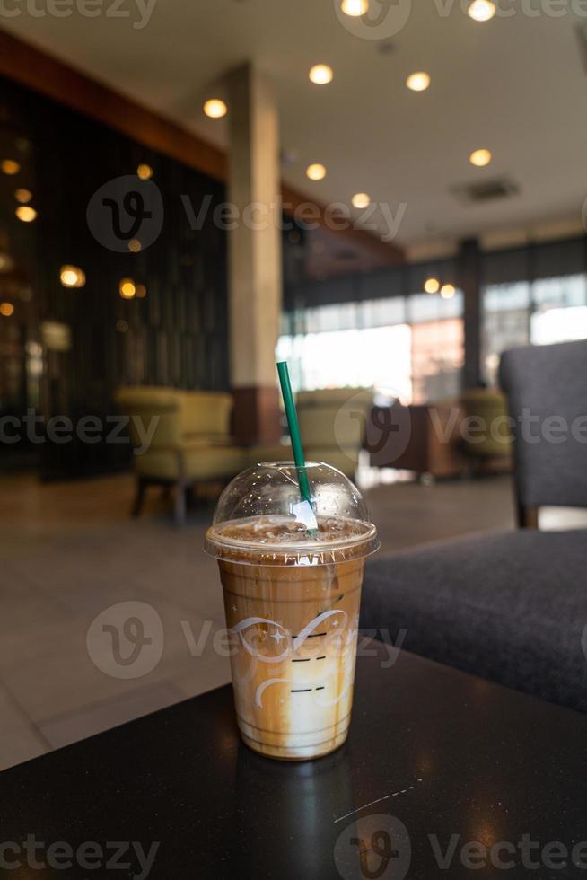 caramel macchiato coffee cup in coffee shop photo