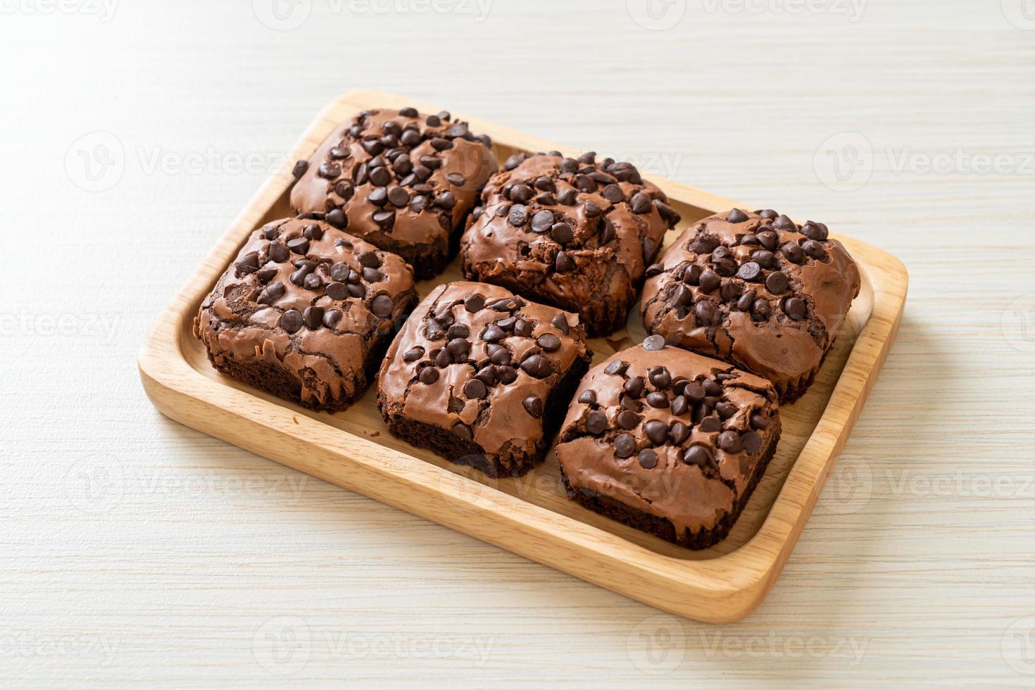 dark chocolate brownies topped by chocolate chips photo