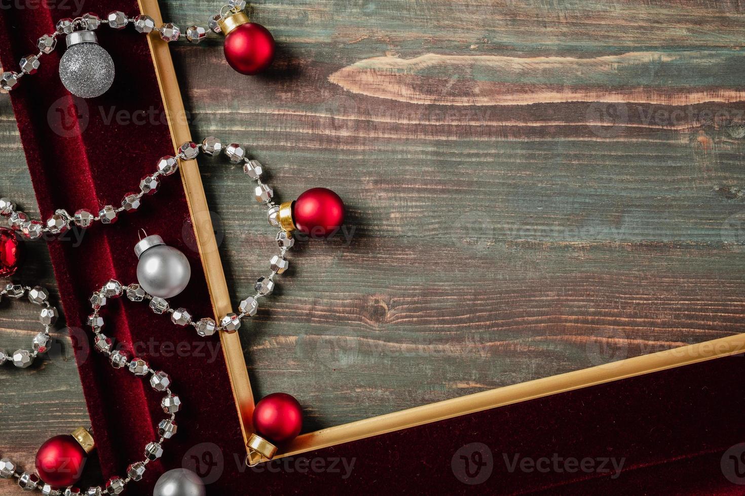 Christmas decoration ornament tiensel,ball and red frame n table wood background photo