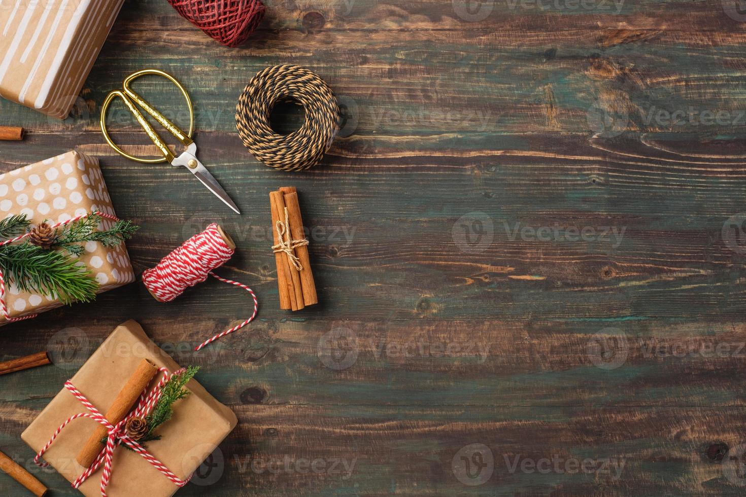 Handmade christmas gift box with brown paper decor with pine fir on wood table photo