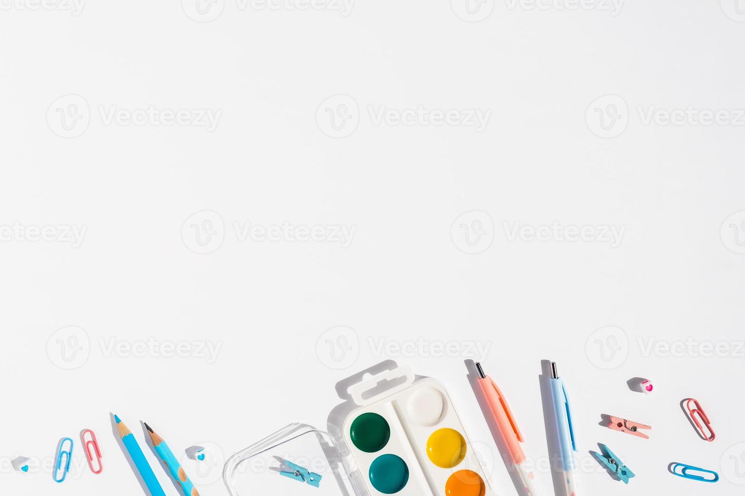 White background with pens and pencils for school advertising. photo