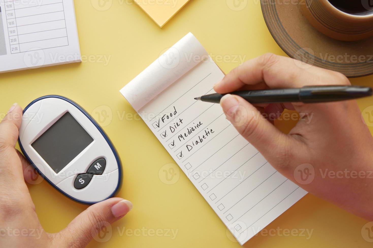 check mark on a check box on a paper with glucose meter on table photo