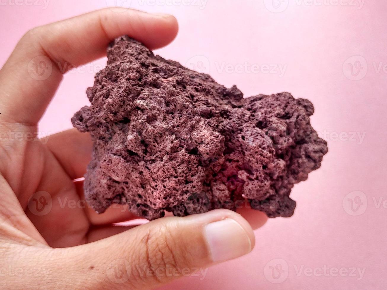 specimen Scoria igneous rock, brownish red color from the Rinjani volcano, Indonesia. Basaltic lava, oxidation of iron during eruptions. Rocks and minerals identification photo