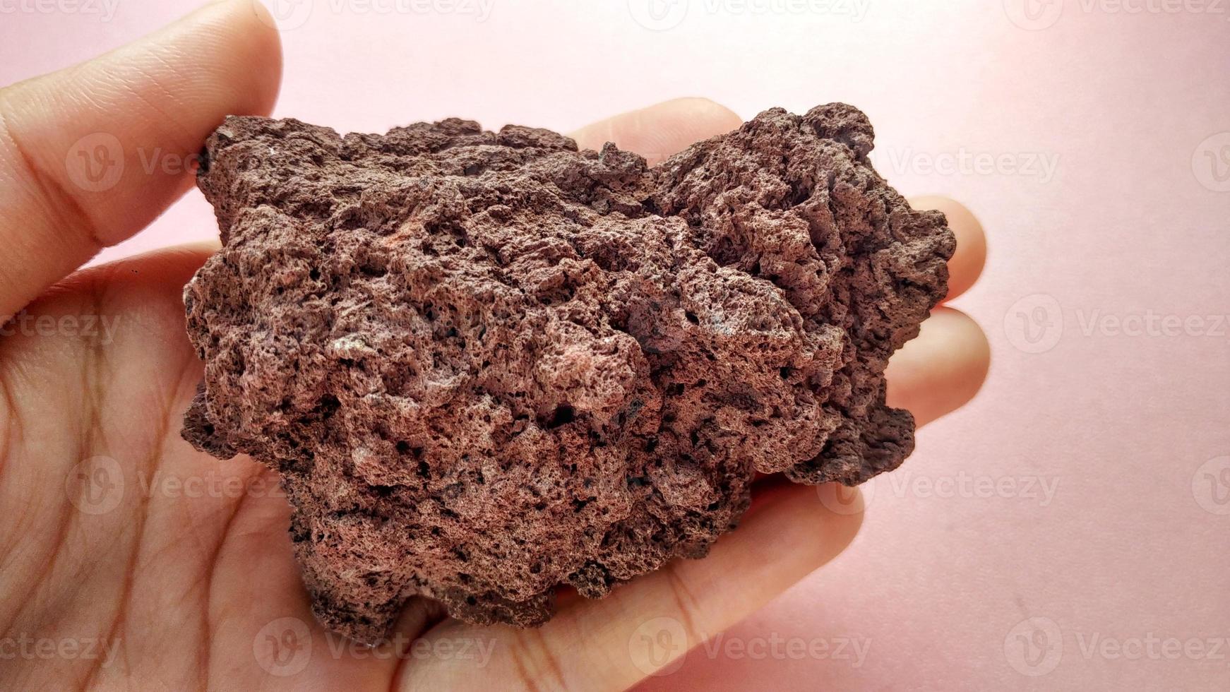 specimen Scoria igneous rock, brownish red color from the Rinjani volcano, Indonesia. Basaltic lava, oxidation of iron during eruptions. Rocks and minerals identification photo