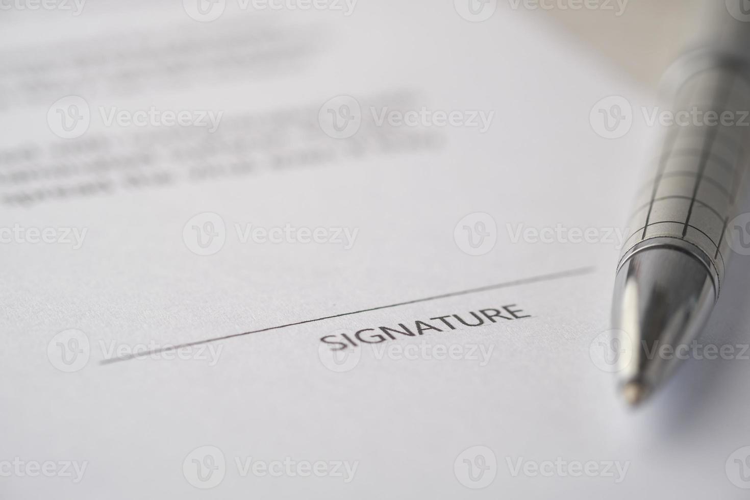 close up of signature on a contact on table photo