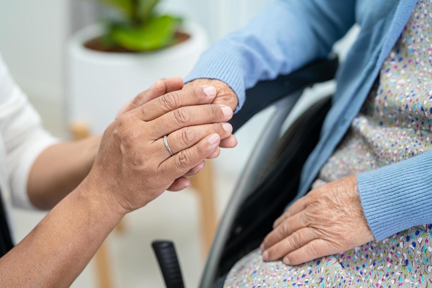 Holding hands Asian senior or elderly old lady woman patient with love, care, encourage and empathy at nursing hospital ward, healthy strong medical concept photo