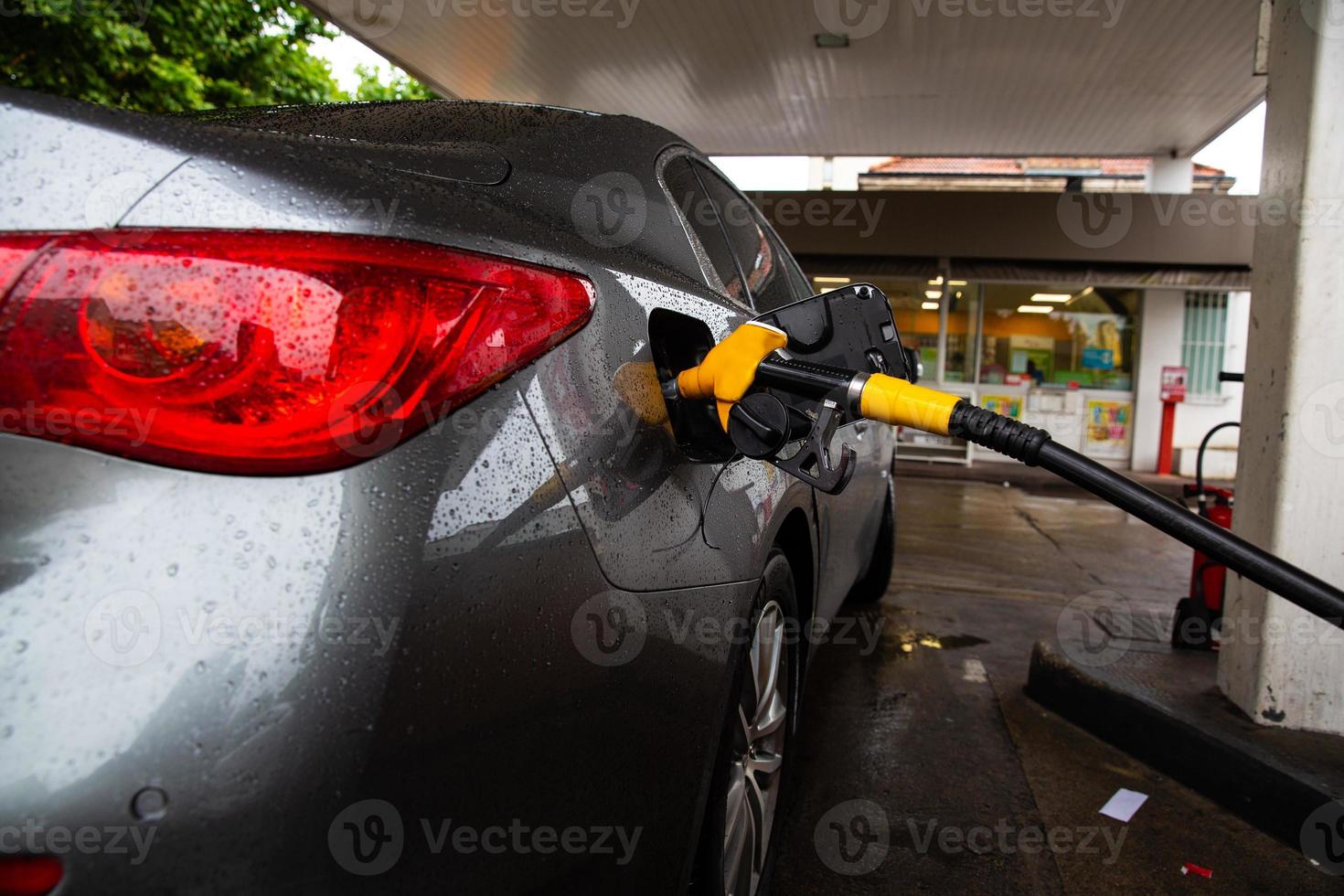 The car is refueling at the gas station. Refueling automobile with gasoline or diesel with a fuel dispenser. photo