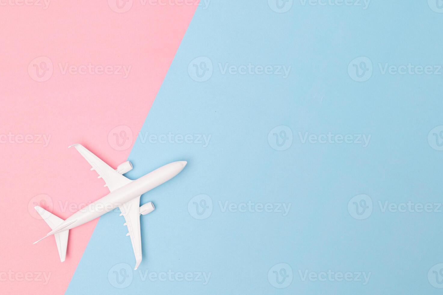 A plane on a pink and blue background photo